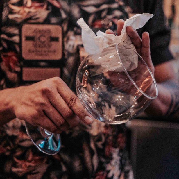 person-wiping-wine-glass-3092970